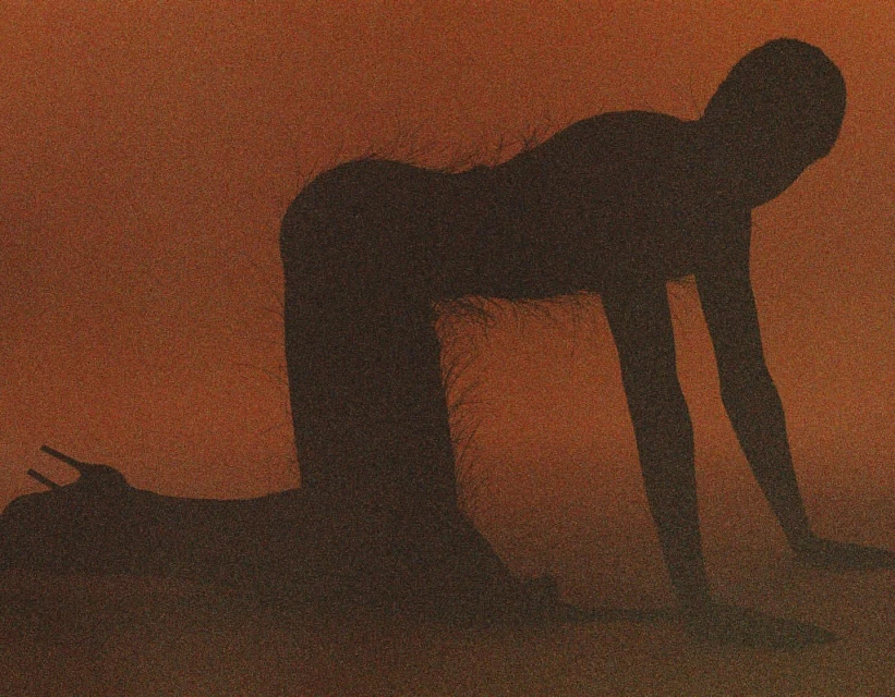Silhouette of a person in a kneeling pose with high-heeled shoes against a textured, orange background creating a dramatic, minimalist image.