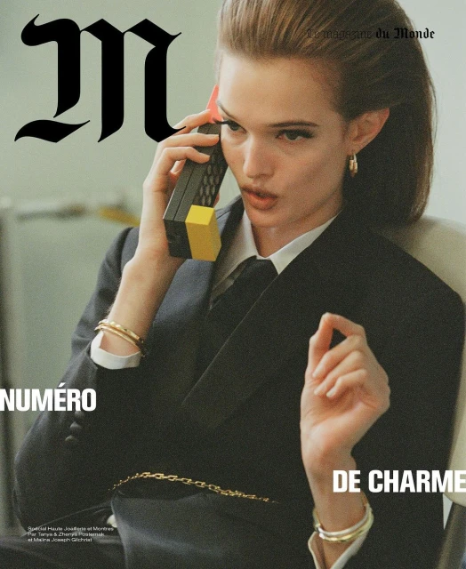 Fashion editorial cover featuring a woman in a suit using a retro brick phone, with 'M le magazine du monde' text overlay.