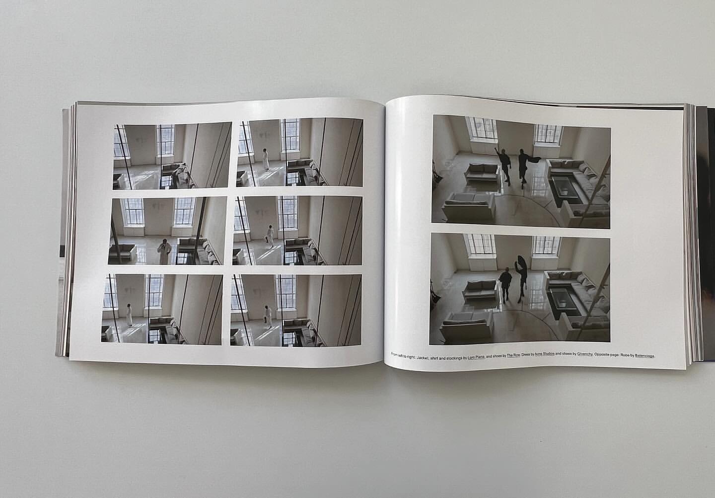 Open magazine pages featuring interior photography with figures in an open-plan architectural space and multiple tiled inset images.