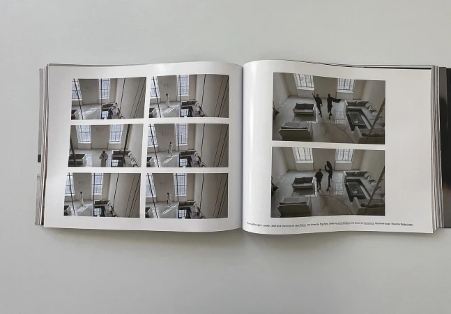 Open magazine pages featuring interior photography with figures in an open-plan architectural space and multiple tiled inset images.