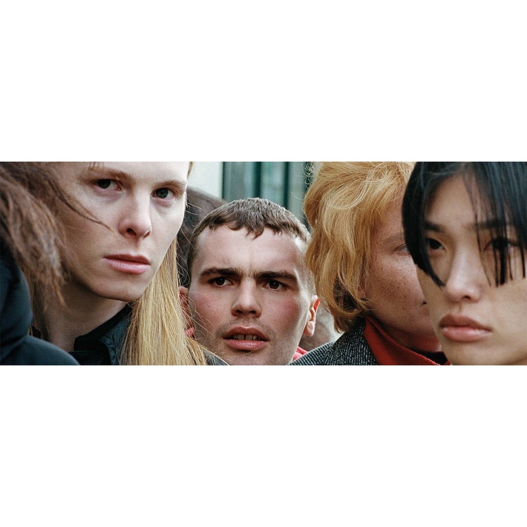Close-up portrait of a diverse group of people including Asian and Caucasian individuals, with various hairstyles and expressions.