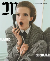 Woman in grey plaid suit holding a telephone receiver with a surprised expression, photographed by Tanya and Zhenya Posternak