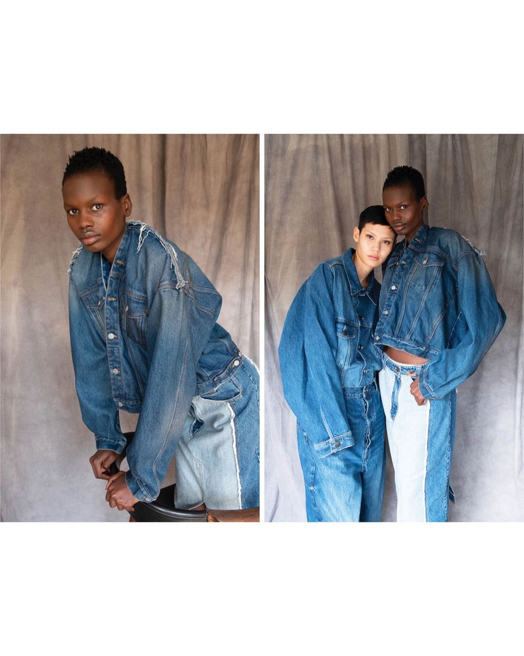 Two women wearing oversized denim jackets and two-tone jeans pose against a mottled grey backdrop in a fashion-forward studio shot.