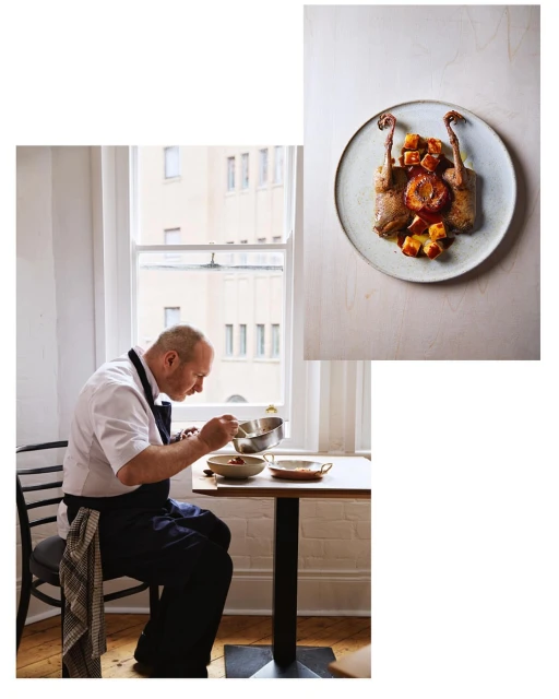 Chef preparing food in a brightly lit interior with a cooked partridge served on a plate visible nearby, culinary arts.