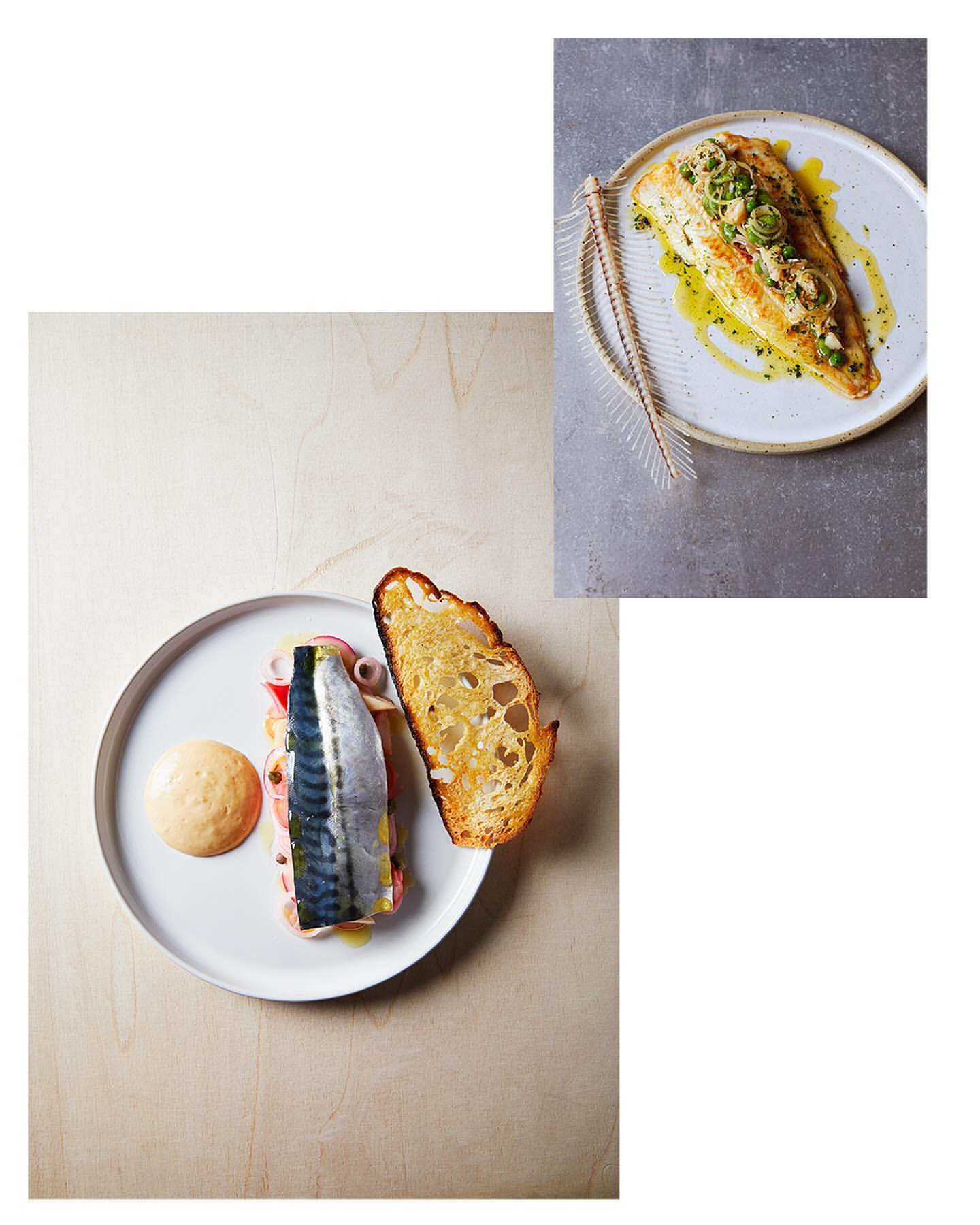 Overhead shot of two plates featuring fish, bread, and garnish. One plate presents fish garnished with greens and oil. The other has fish with bread.