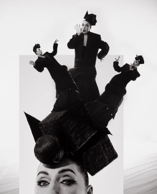 Black and white art photography features woman with elaborate headpiece and multiple full-body reflections against a stark white background.