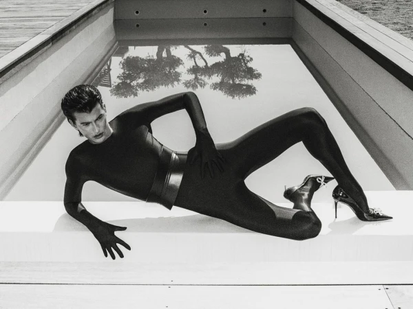 Man wearing a black bodysuit and heels lying by a swimming pool in London shot by Tarek Mawad