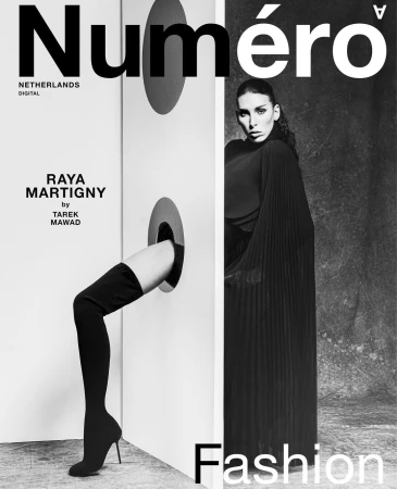 Black and white fashion magazine cover with woman in dress and a leg sticking through a hole, text reads 'Numero Netherlands Digital'.
