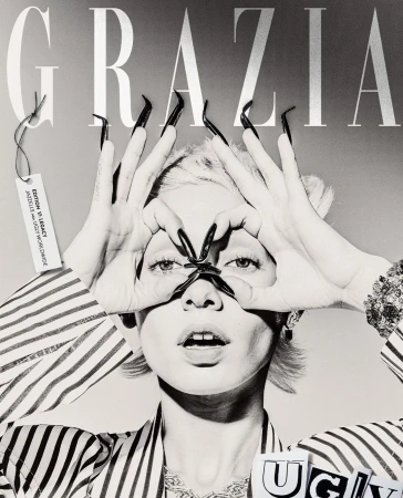 Black and white fashion editorial cover with a woman making a frame around her eyes with long nails and Grazia magazine logo.