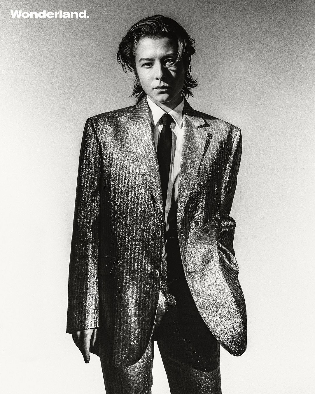 Portrait of a person in a metallic blazer and tie against a light background by Tarek Mawad