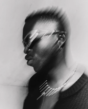 Black man wearing sunglasses and hoop earring in a motion blur photographic portrait by Tarek Mawad