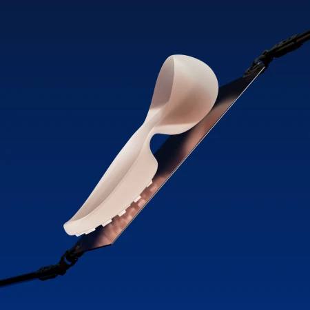 Abstract product shot of white shoe insert on a metal blade, angled against a dark blue background, showcasing design and product details.