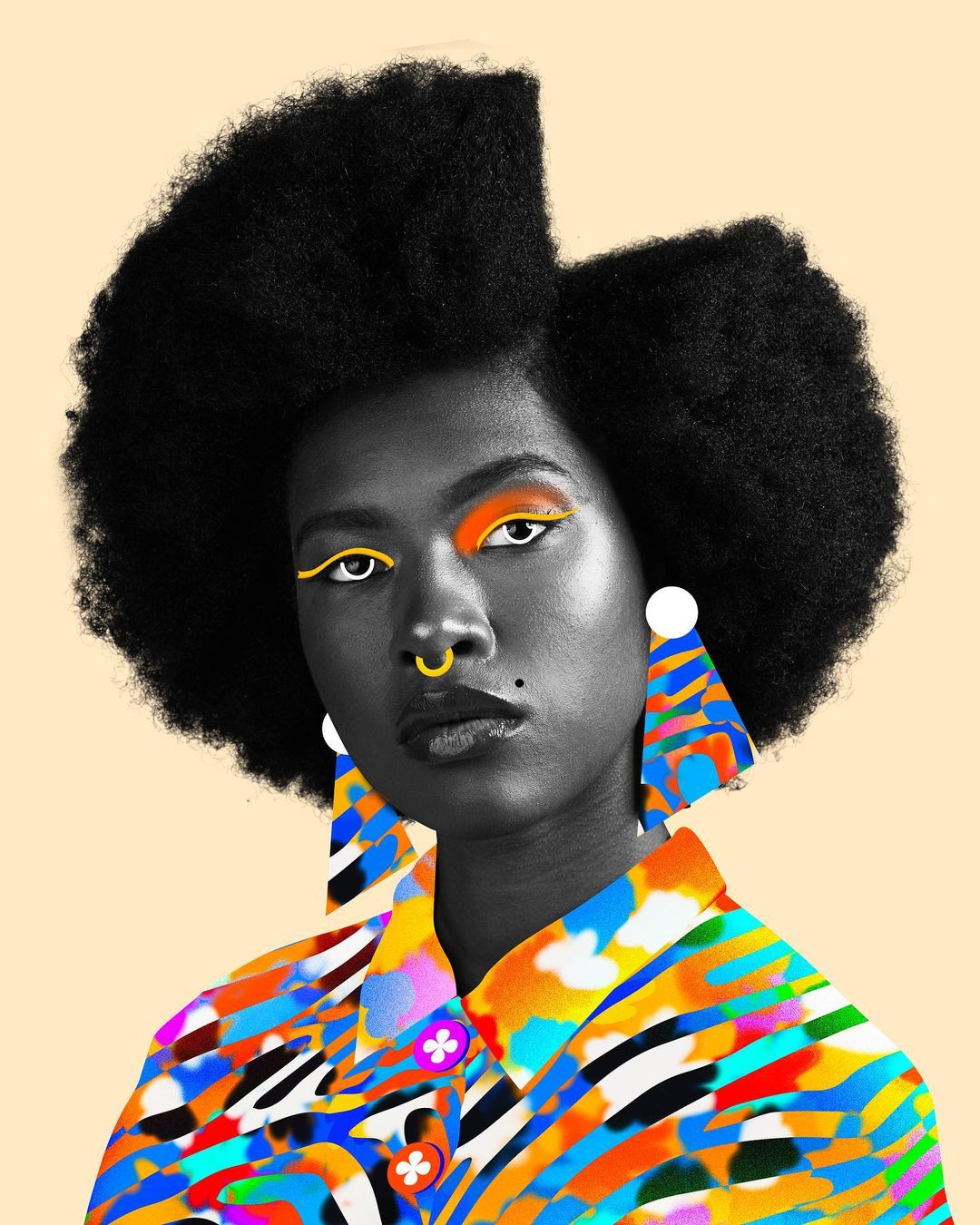 Eye-level portrait of a Black woman with a large afro wearing a multicolored patterned shirt and large earrings against a light peach background.