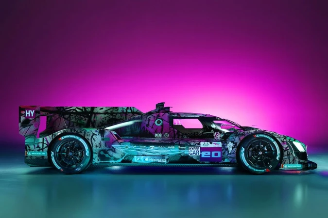 A vividly colored race car, displayed in a profile shot, showcasing its aerodynamic design against a vibrant pink and blue backdrop.