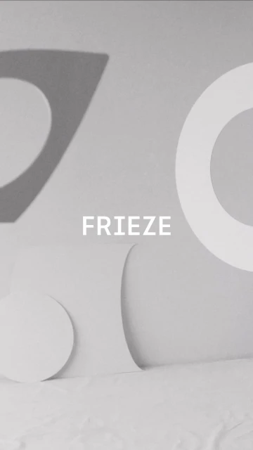Abstract monochromatic image with white geometric shapes against a light gray background, including the word FRIEZE in the center.