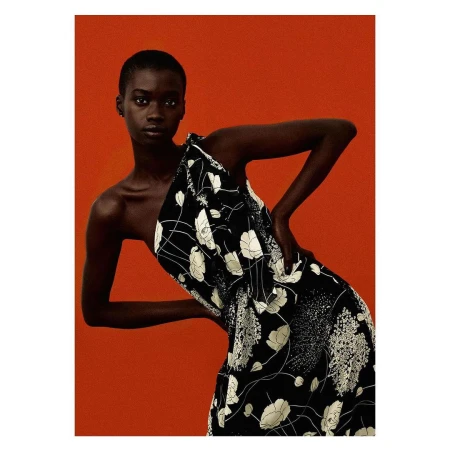 Model with short hair wearing a black and white floral one-shoulder dress against a textured red background by The Bardos