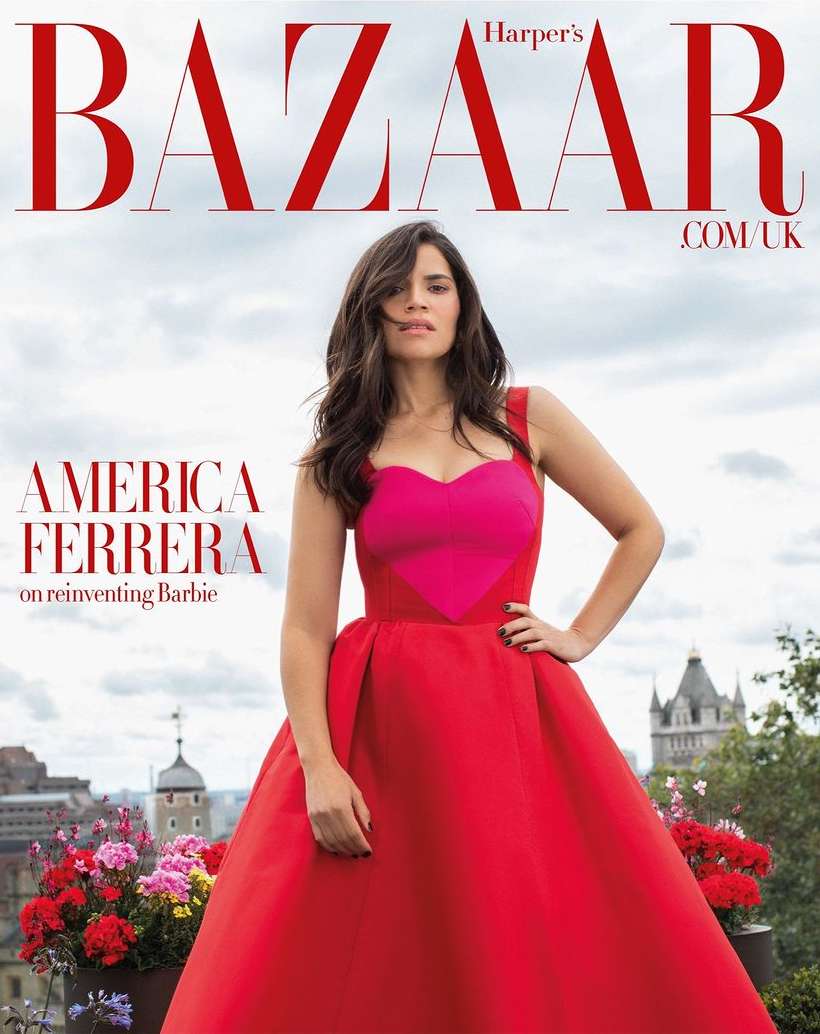 Magazine cover featuring America Ferrera in a red gown posing outdoors with a cityscape backdrop and floral accents. Harper's Bazaar masthead.