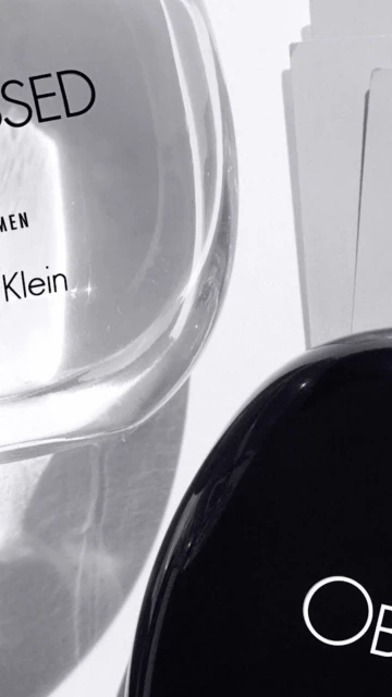 Two bottles of Calvin Klein Obsessed perfume, one with a clear bottle and black cap and the other with a black bottle and white text.