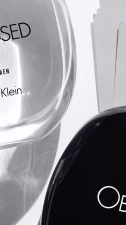 Two bottles of Calvin Klein Obsessed perfume, one with a clear bottle and black cap and the other with a black bottle and white text.