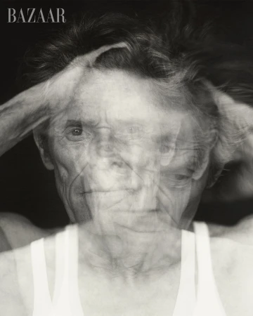 Monochromatic portrait featuring an elderly person with short hair against a dark background. The image shows multiple exposures.