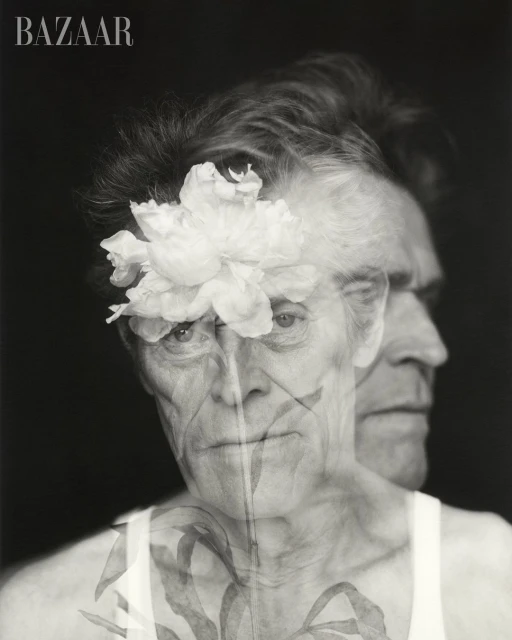 Monochrome portrait of older man with flower overlay and Bazaar logo, artistic style, and a sense of depth from dual-profile effect.