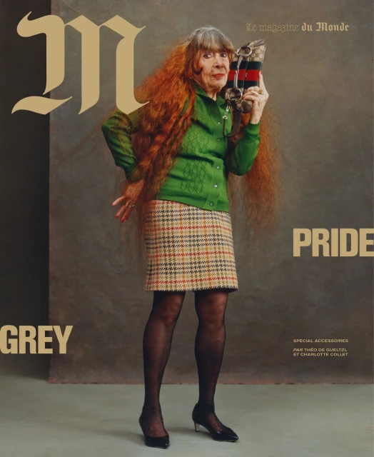Magazine cover shot: An elderly woman with long, auburn hair poses in a green sweater and plaid skirt, holding a Gucci clutch.