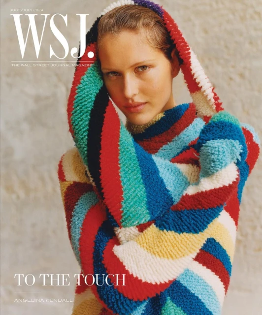 Magazine cover featuring a woman wearing a colorful knitted hoodie sweater, photographed in a studio setting with neutral backdrop.