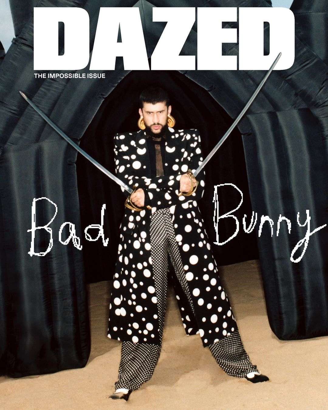 Bad Bunny poses on Dazed magazine cover in a polka dot suit, holding swords, in front of an inflatable background. Magazine cover.