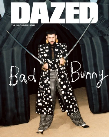 Bad Bunny poses on Dazed magazine cover in a polka dot suit, holding swords, in front of an inflatable background. Magazine cover.