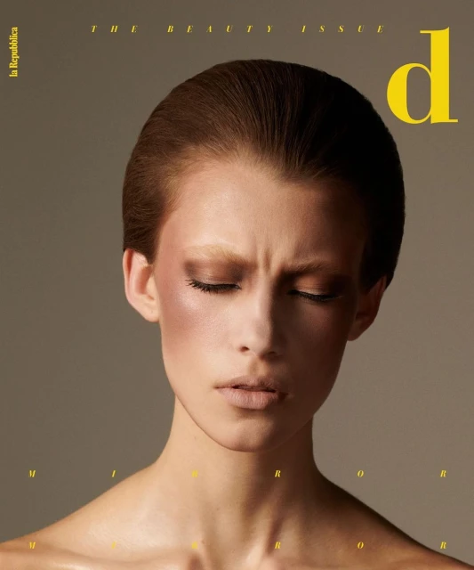Magazine cover featuring a woman with fair skin and closed eyes, showcasing beauty editorial makeup and a simple, elegant background.