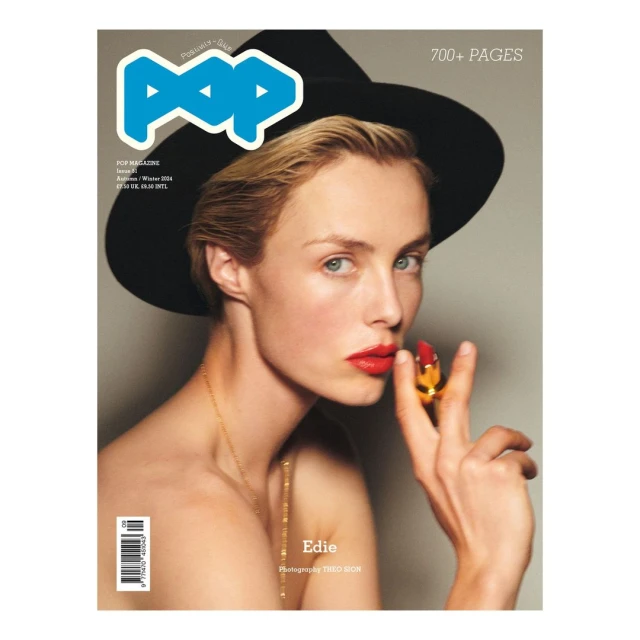 Magazine cover featuring a portrait of a model with lipstick, wearing a hat and gold necklace, with the magazine title 'POP' at the top.
