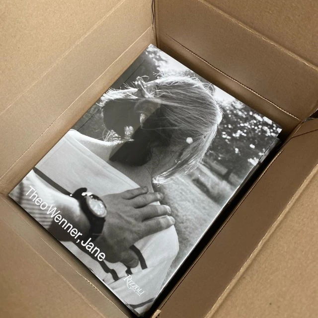 Black and white photo book inside a cardboard box, featuring a portrait of a woman and the text 'Theo Wenner, Jane' on the cover.