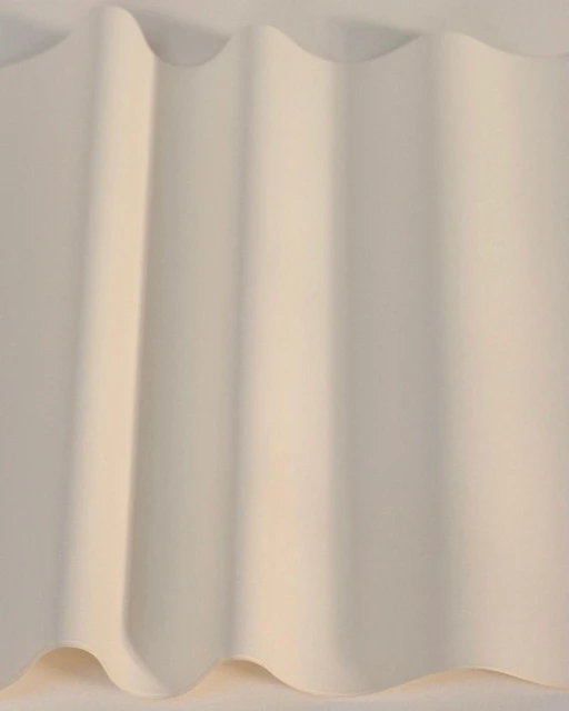 Abstract view of a gently folded sheet with soft, diffused lighting creating subtle shadows, highlighting the texture and form.