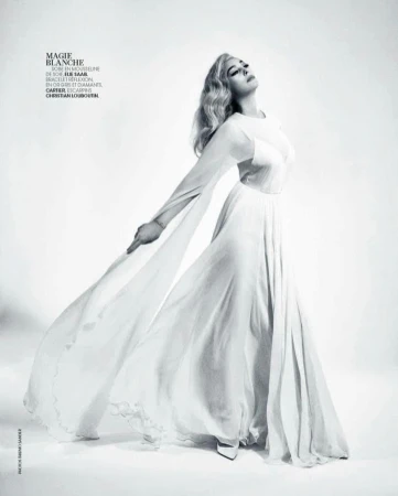 Model in long white silk chiffon dress with flowing sleeves against a white background by photographer Thiemo Sander.
