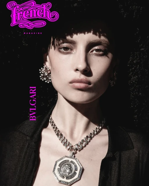Editorial portrait of a woman with dark hair and a statement necklace, featuring the French Magazine logo and Bulgari branding against a dark background.