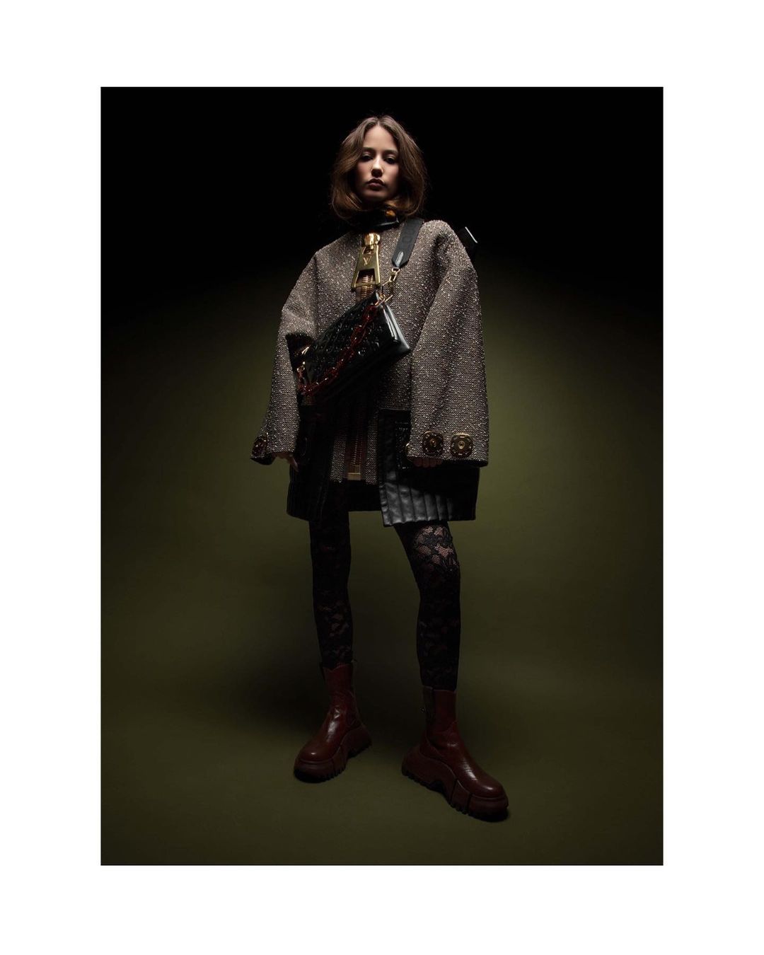 Model wearing a textured tweed jacket, lace leggings, and red boots, photographed by Thierry Le Gouès in Milan.