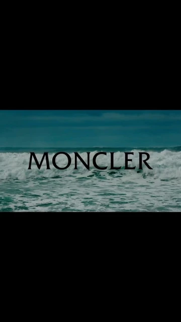 Waves crash in the ocean with 'MONCLER' text overlay, capturing a cinematic scene with a nature and fashion crossover.