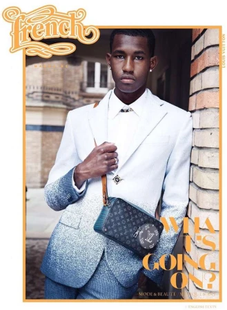 Magazine cover featuring a young man wearing a white suit with blue ombre, accessorized with a Louis Vuitton bag and jewelry.