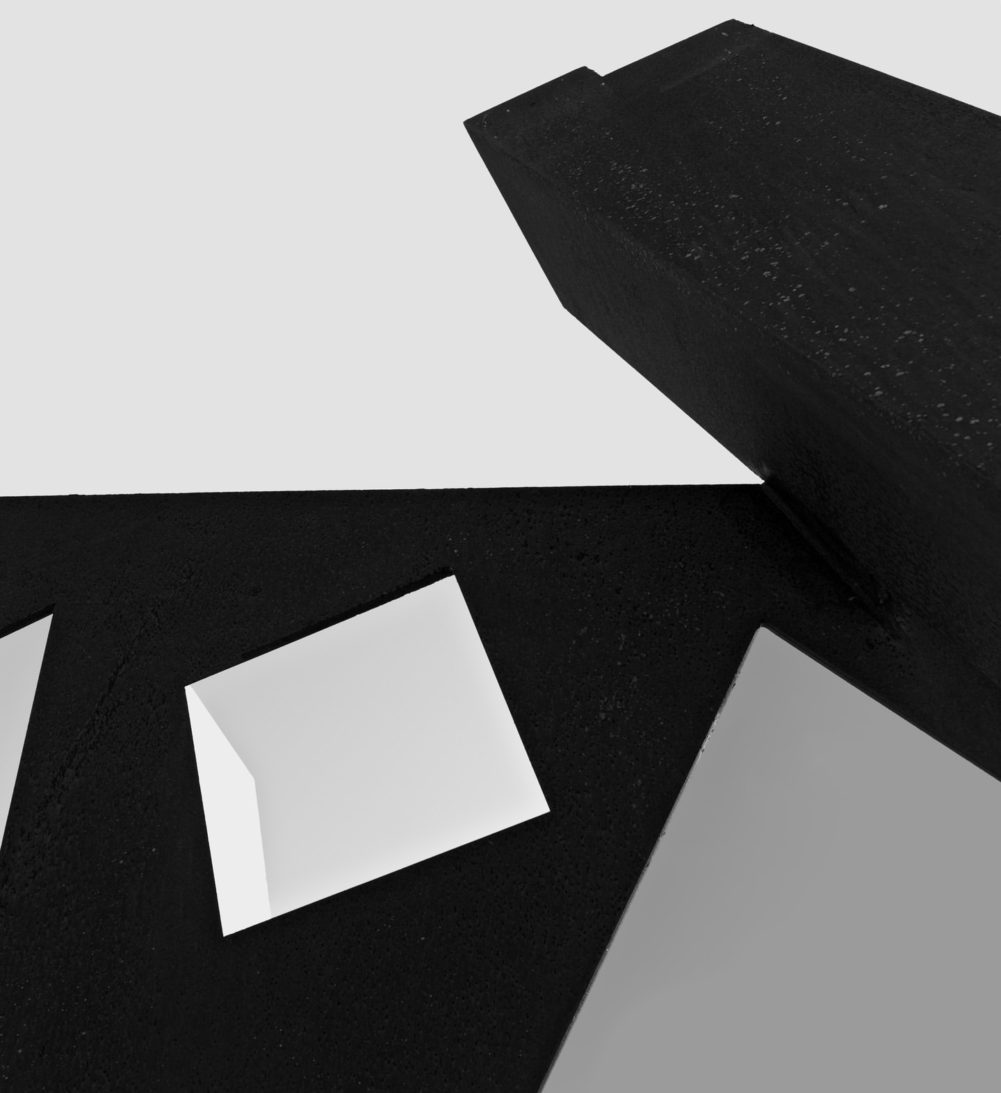 Black and white abstract geometric composition featuring angled geometric shapes against a light background, creating a modern design.