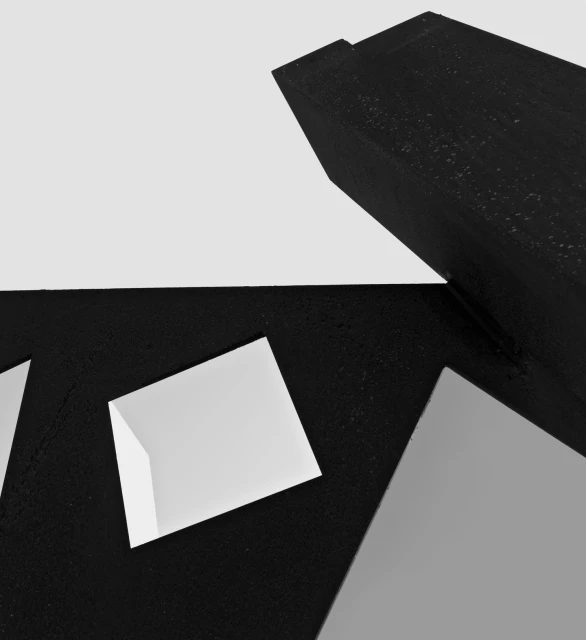 Black and white abstract geometric composition featuring angled geometric shapes against a light background, creating a modern design.