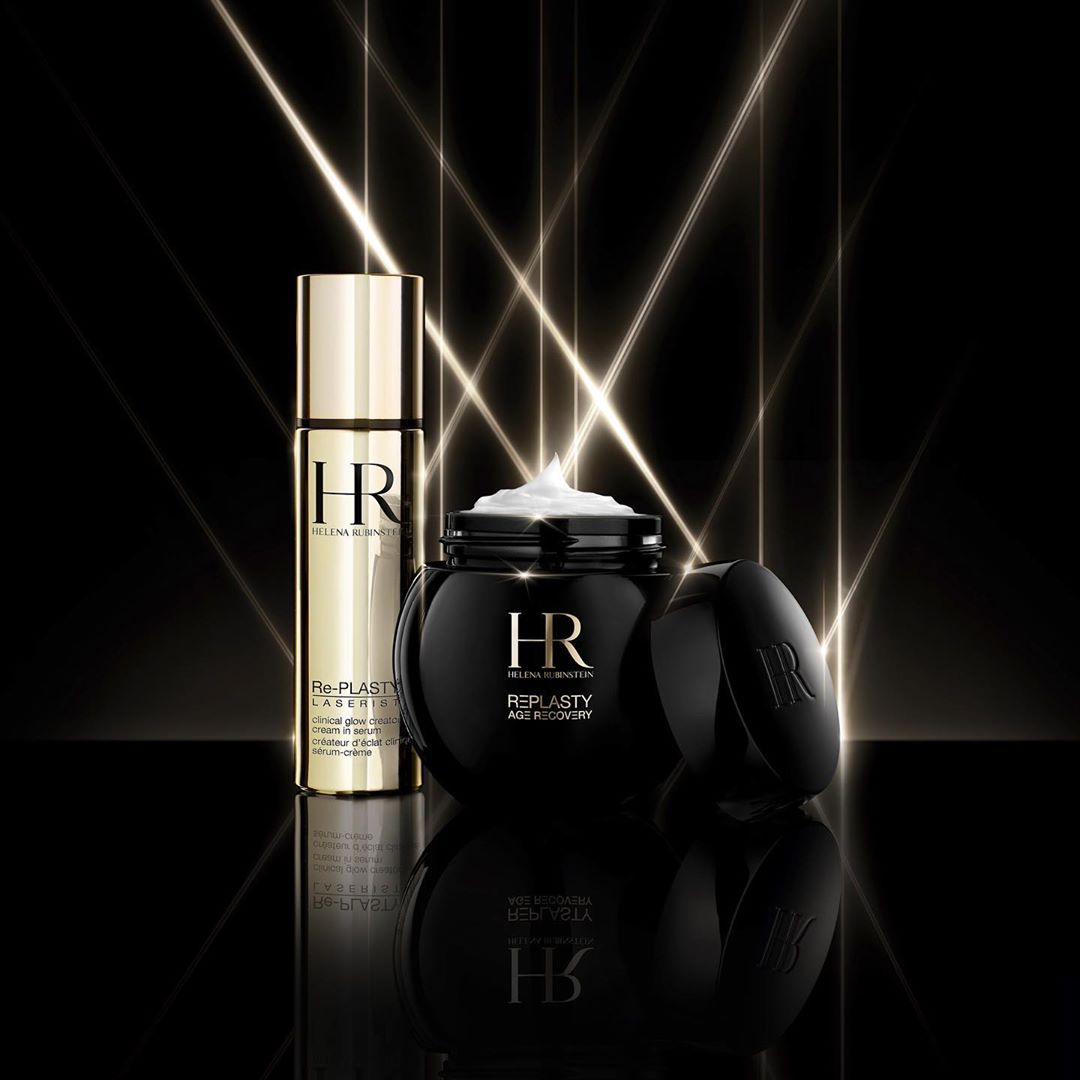 Two Helena Rubinstein Re-Plasty skincare products, a cream and serum, are showcased against a dark backdrop with linear light effects.