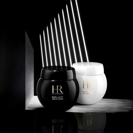 Two jars of Helena Rubinstein Re-Plasty Age Recovery skincare products, one black and one white, on a reflective surface.