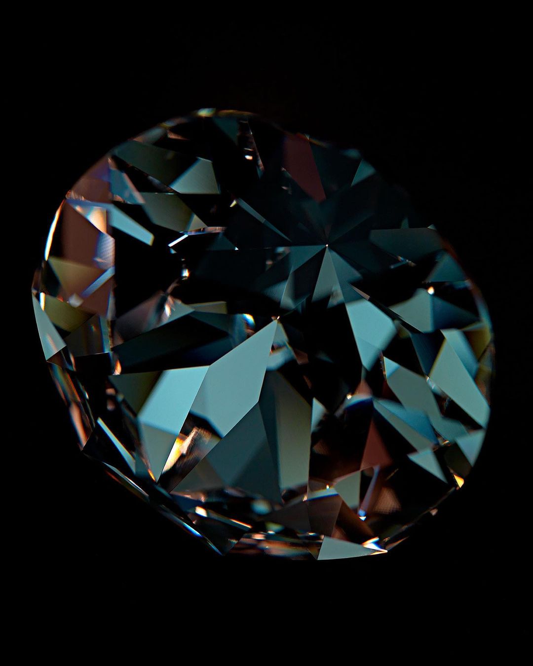 Close-up of a faceted blue and brown gemstone against a black background, showcasing its intricate cut and color variations.