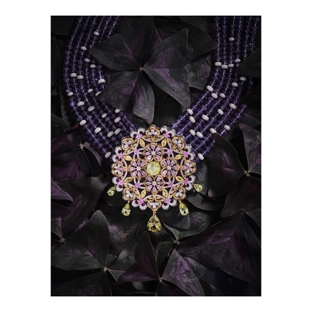 Ornate floral necklace with purple bead strands on a dark floral background. Jewelry photography for fashion and luxury advertising.