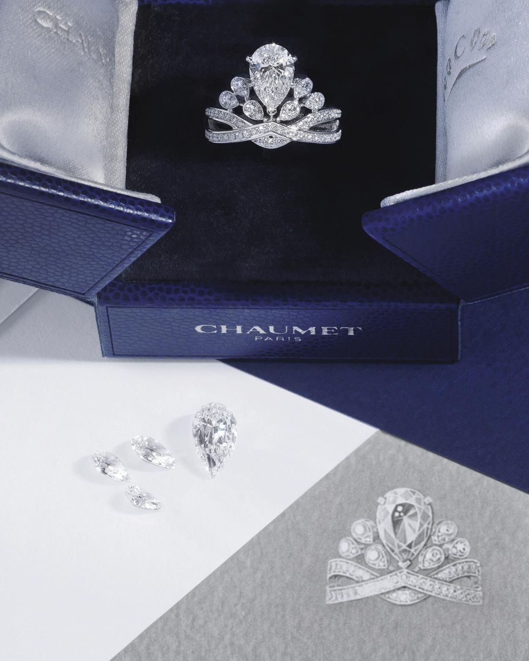 Close-up of a Chaumet tiara in its box, several loose diamonds, and a sketch of the tiara on a divided white and gray surface.