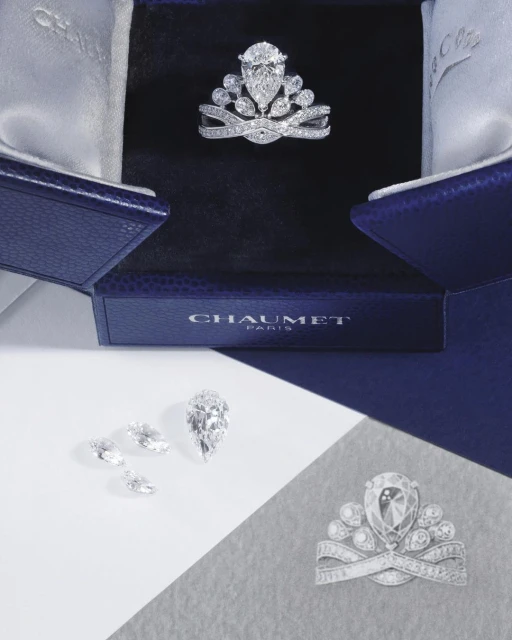 Close-up of a Chaumet tiara in its box, several loose diamonds, and a sketch of the tiara on a divided white and gray surface.