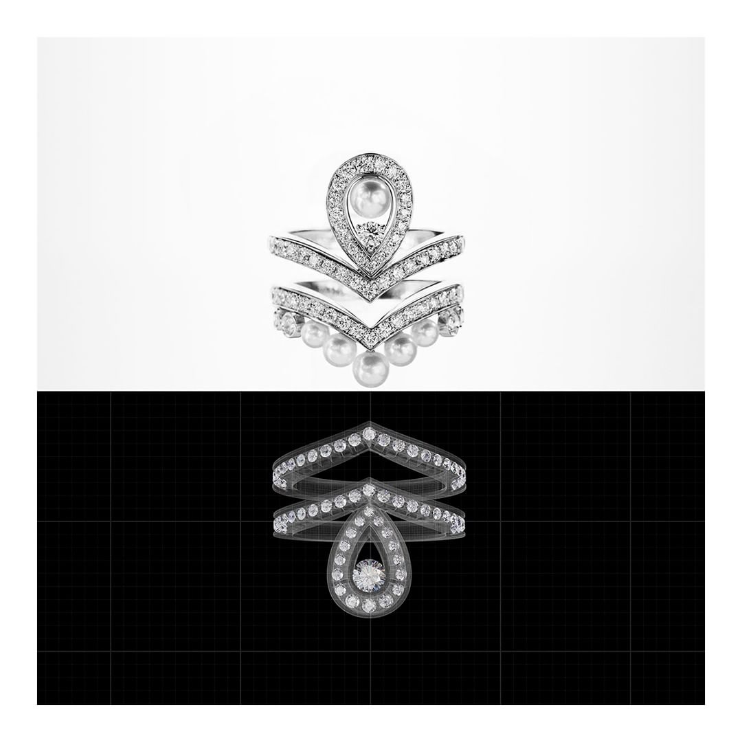 Stylized silver ring with pearls and diamonds on a split background of white and black featuring a reflection of the ring.