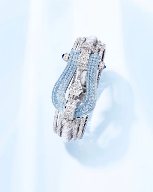Elegant diamond bracelet with blue gemstones set on a gradient blue backdrop for jewelry advertising, high-end fashion accessory.