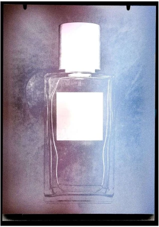 Elegant close-up of a clear glass perfume bottle with a white cap against a soft, textured background in shades of blue and pink.