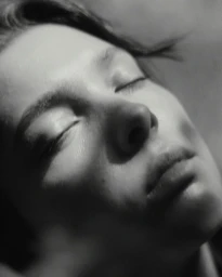 Close-up portrait of a woman with closed eyes captured in monochrome by photographer Tijl Dhe Nije